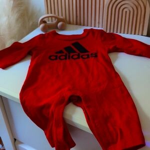 New without tags, Adidas long sleeve red jumpsuit with button closure.